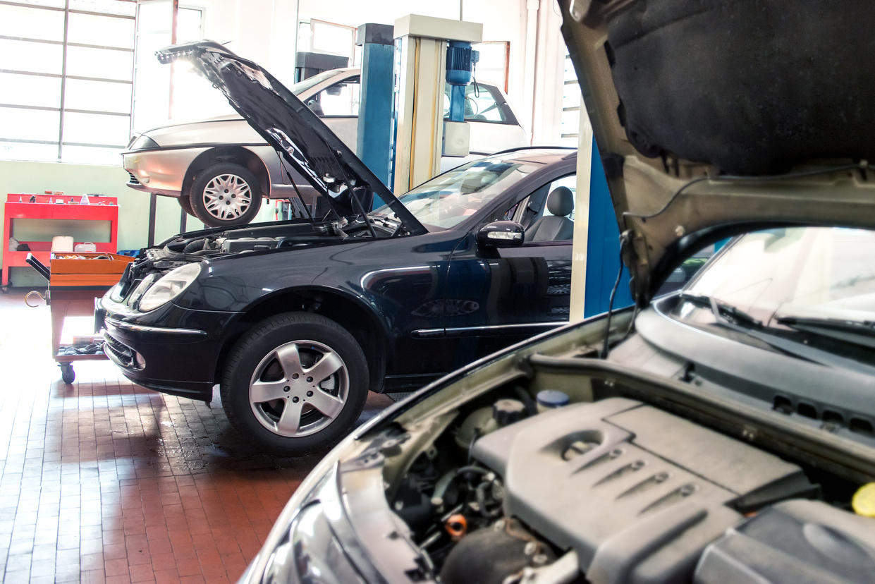 Three Cars in a Repair Shop